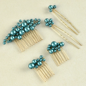 Detail of bridal hair set with teal pearls and gold wire combs and hairpins