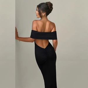 Sleek backless strapless black maxi dress featuring a deep V-cut and elegant ruched details