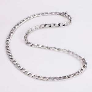 Detail of silver Cuban chain necklace with textured links in an S-shape arrangement