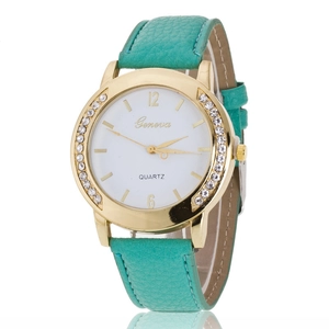 Detail of mint green leather strap and gold rhinestone case on Geneva quartz watch