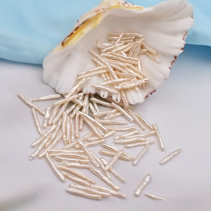 Macro view of natural baroque freshwater stick pearls spilling from a white seashell