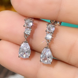Macro detail of silver pear cut teardrop earrings with sparkling micro-pave cubic zirconia
