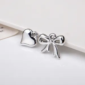 Silver metallic heart and bow charms with high-polish finish for DIY jewelry making
