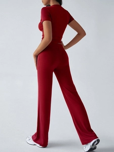Back view of women casual red short-sleeve top and long pants set in professional studio