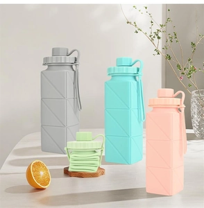 Detailed view of colorful collapsible silicone water bottles in expanded and folded states