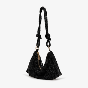 Detail of black rhinestone shoulder bag with crystal mesh texture and gold zipper accent