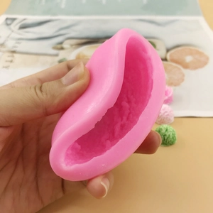 Pink food-grade silicone ice cream and mousse mold held by hand for baking