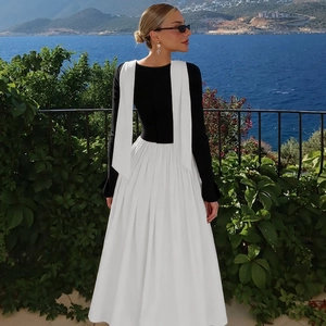 Elegant contrast pleated dress back view with seaside scenery and long black sleeves