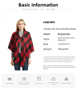 Detail view of red plaid shawl showing horn buckle closure and fringe tassels