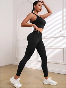 Macro detail of high-waist yoga leggings and sneakers against a window shadow background