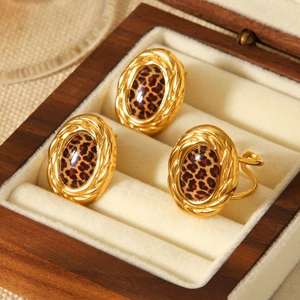 Close-up of 18k gold-plated jewelry set with leopard print resin in a wood box
