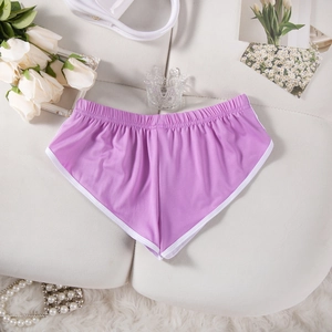 Detail der lila Sportshorts mit weißer Kontrastpaspelierung auf weichem Hintergrund
