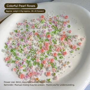 Macro detail of 8mm pink resin roses, green leaves and pearls for DIY nail art kits