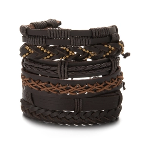 Detail of layered brown leather woven bracelets with intricate braid and metal beads