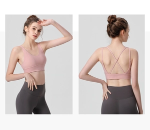 Pink sports bra with crossover back straps and V-neckline for yoga fitness workout