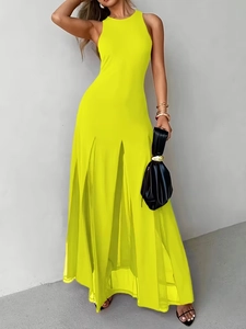 Detail of neon yellow sleeveless halter maxi dress with side slit and elegant flowing hem