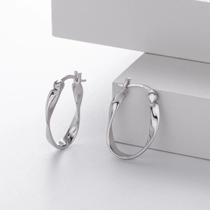 Close-up of S925 sterling silver Mobius twist earrings showing the hallmark and texture