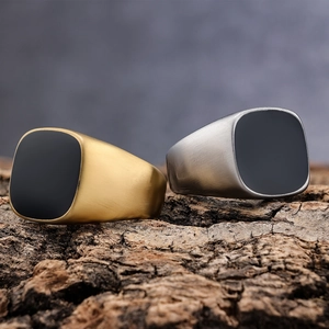 Brushed stainless steel men's signet rings with black square stone inlay on wood