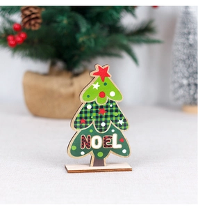 Detail of wooden Christmas tree decor with NOEL lettering on a festive desktop background