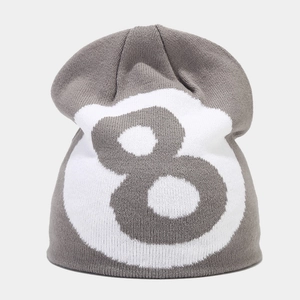 Close-up of grey knit beanie featuring white number 8 jacquard pattern and soft texture