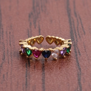 Detail shot of rainbow heart-shaped zircons set on a gold-plated open ring band