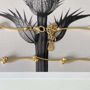 Detail of S925 sterling silver golden bead necklace with lobster clasp and hallmark