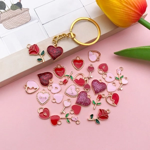 Flat lay of heart and rose alloy enamel charms for DIY jewelry and keychain making