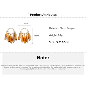 Detail view of oval amber glass earrings with copper base, size 3.5cm by 2.5cm