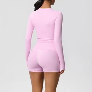 Close-up back view of pink long sleeve yoga top and high waist shorts set