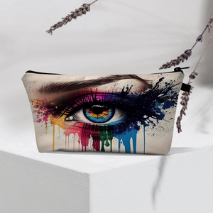 Detail view of beige canvas makeup bag with evil eye print and colorful splash art pattern