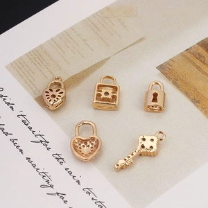 Five gold-plated heart lock and key pendants with zircon inlay on a vintage beige card