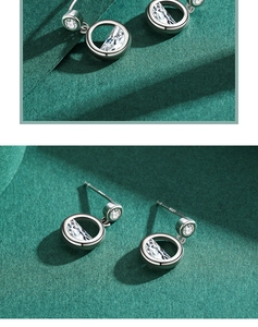 Detailed macro view of S925 sterling silver earrings with crescent cubic zirconia stones