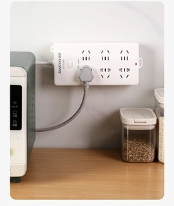 Detail view of wall-mounted power strip with switch and 2500W load capacity