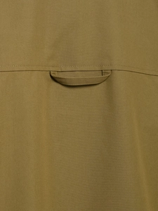 Detail of cargo-style brown twill fabric showing fine texture and a sewn-on utility loop