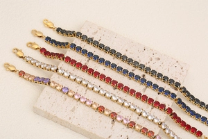 Detail of five 18K gold plated tennis bracelets with colorful inlaid cubic zirconia stones