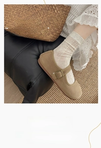 Detail of apricot hollow knit crew socks with bow patterns paired with brown shoes