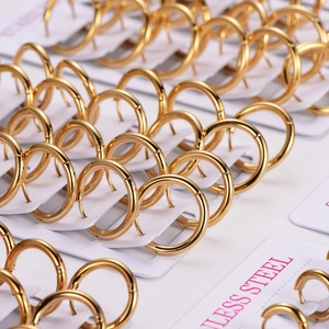 Polished gold stainless steel hoop earrings neatly arranged on white display cards