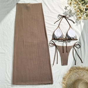Detailed flat lay of brown three-piece bikini set with knit texture and matching mesh skirt