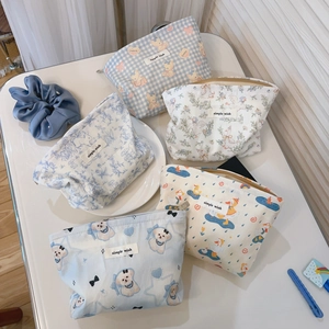 Detail shot of cute blue cartoon cotton makeup bag with smooth zipper and fabric label