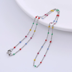 Detail of a silver O-chain necklace featuring multi-colored beads and a lobster clasp