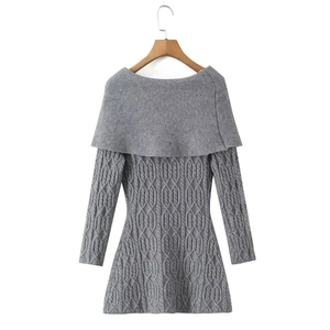 Detail of grey cable knit dress showing off-the-shoulder collar and textured weave pattern