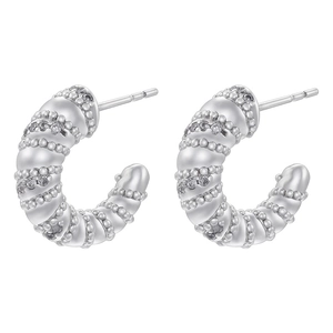 Detail view of silver C-shaped earrings with spiral texture and crystal micro-pave setting