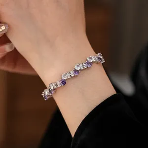 Elegant silver bracelet featuring round and pear-cut purple cubic zirconia crystals