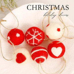 Red and white wool felt Christmas ornaments with snowflake patterns and jute strings