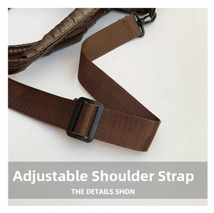 Detail of adjustable black nylon shoulder strap on a quilted brown crossbody bag