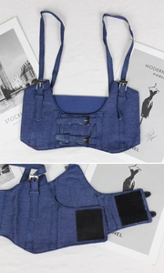 Close-up of blue denim corset belt featuring adjustable straps and velcro fastening