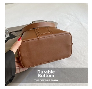 Close-up of the durable wear-resistant base on this vintage dark brown leather bucket bag