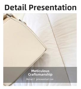 Close-up of precise stitching on structured beige PU leather handbag corner