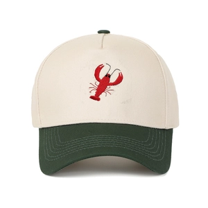 Detailed view of red lobster embroidery on two-tone cotton baseball cap with green visor