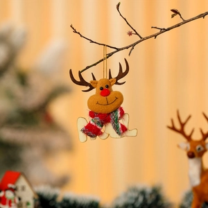 Detail of felt reindeer Christmas ornament with wooden NOEL lettering and gold hanging string